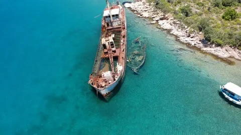 Aerial view over rusty shipwreck of an old cargo boat at Peristera island nea Stock Footage 201450284
