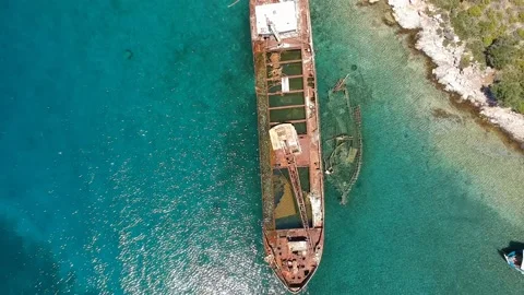 Aerial view over rusty shipwreck of an old cargo boat at Peristera island nea Stock Footage 201451165