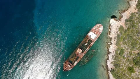 Aerial view over rusty shipwreck of an old cargo boat at Peristera island nea Stock Footage 201451505