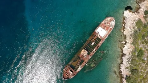 Aerial view over rusty shipwreck of an old cargo boat at Peristera island nea Stock Footage 201453334