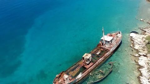 Aerial view over rusty shipwreck of an old cargo boat at Peristera island nea Stock Footage 201454385