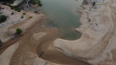 Aerial view over sandy beach landscape with small vegetation dunes. Stock Footage 280243232
