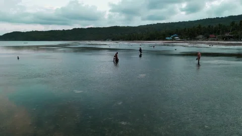 Aerial View Over A Shallow Beach With People Walking Stock Footage 209873143