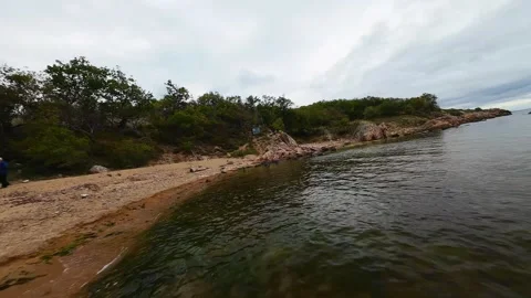 Aerial view over a small bay with a wild beach, located in the forest, Paraskeva Stock Footage 288034592