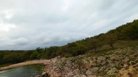 Aerial view over a small bay with a wild beach, located in the forest, Paraskeva Stock Footage 288034678