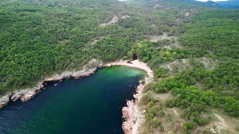 Aerial view over a small bay with a wild beach, located in the forest, Paraskeva Stock Footage 288034718