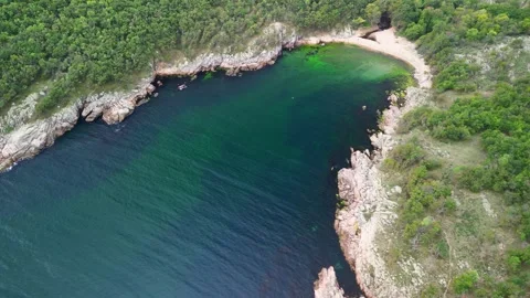 Aerial view over a small bay with a wild beach, located in the forest, Paraskeva Stock Footage 288034730