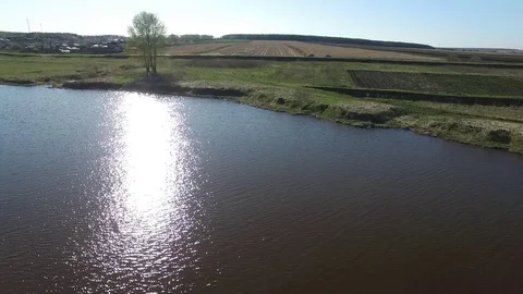 Aerial view over the small lake and island surrounded by forests. Footage. Lake Stock Footage