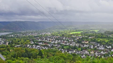 Aerial view over small scenic town of Rhens surrounded by rolling hills Stock-Footage 303674028
