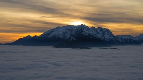 Aerial View over Snow-capped Mountain in Sunset with Cloudscape Stockbeeldmateriaal 127152902