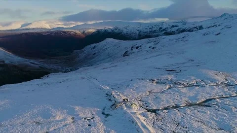 Aerial view over snow-covered moorland in the Lake District Stock Footage 345299810