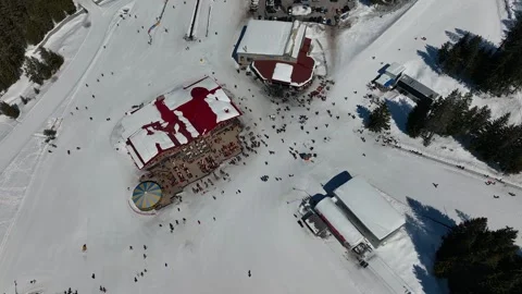 Aerial view over snowy mountain winter forest with chair lift at ski resort Stock Footage 251853316