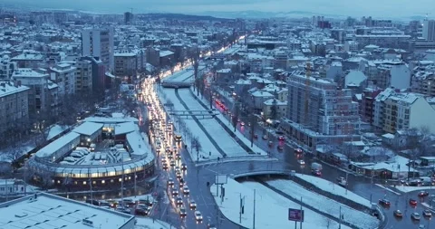 Aerial view over snowy Sofia city with large boulevard with traffic movement Stock Footage 261038182