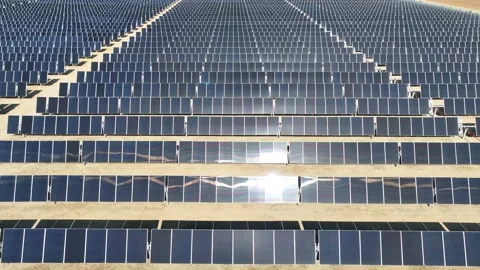 Aerial view over solar panels at solar farm producing sustainable energy Stock Footage 204759144