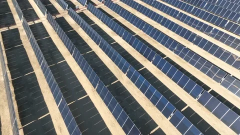 Aerial view over solar panels at solar farm producing sustainable energy Stock Footage 204759196