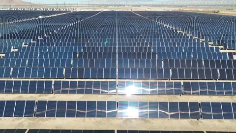 Aerial view over solar panels at solar farm producing sustainable energy Stock Footage 204759197