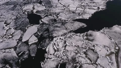 Aerial view over the surface of river and cracked ice Stock Footage 91164995