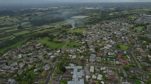Aerial view over Te Puke, New Zealand, featuring a residential area surrounded Stock Footage 300753146