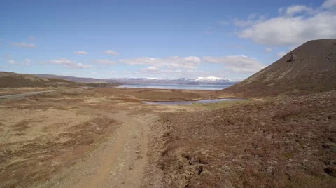 Aerial view over volcanic landscape with rock and lake -  Iceland Stock Footage 64856485