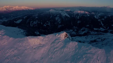 Aerial view over a winter pine forest during a winter sunset Stock Footage 102658059