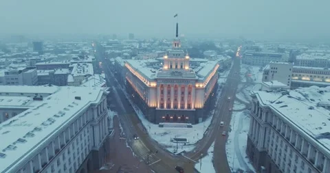 Aerial view over winter Sofia with the parliament building and snowy roofs Stock Footage 297781964