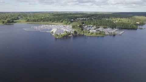 Aerial view over a yacht port on a lake Stock Footage