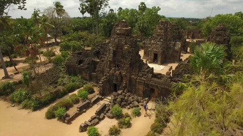 Aerial view over young man tourist sightseeing in Ta Prohm Temple, Cambodia Stock-Footage 83533928
