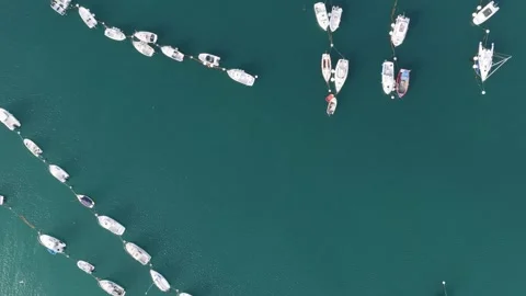 Aerial view of an overhead view of numerous boats and yachts moored in neat rows Stock Footage 346706619