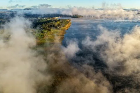 Aerial view overlooking Lake Keepit and the dam wall beneath a dramatic fog.. Stock Photos