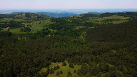 Aerial view pan left of mountain range terrain and dense green forests Serbia Stock Footage 342241319