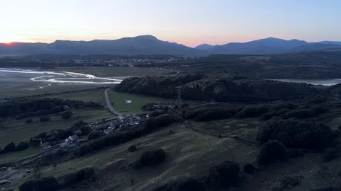 Aerial view, pan move. Drone panorama sunset over Talsarnau village hills, Sn Stock Footage 94247976