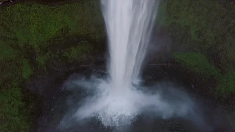 Aerial View, Pan Up On A Waterfall, 3 Hikers Walk On Trail Behind Waterfall Video stock 88345341