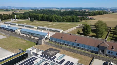 Aerial view panning across the barracks at the Mauthausen Memorial Video stock 342409498