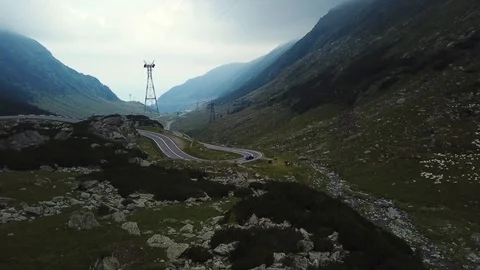 Aerial view panning to left over Transfagarasan road in moody gloomy day Stock Footage 92359908