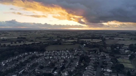 Aerial view, panning move. Dramatic sunset 360 panorama over small town, Tarv Stock Footage 95563967