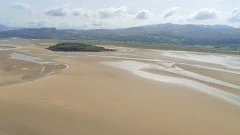 Aerial view, panning move. Drone panorama of island on sea and sand in Snowdo Video stock 94237253