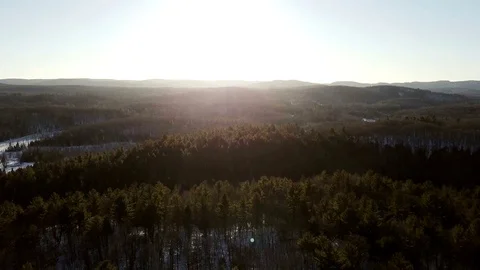 Aerial view panning sideways of Quebec forest at sunset Stock Footage 71477973