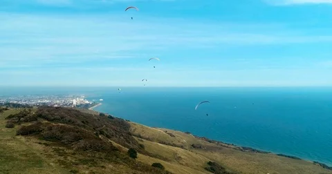 Aerial view of paragliders at Beachy Head, Southern England Stock Footage 80419447