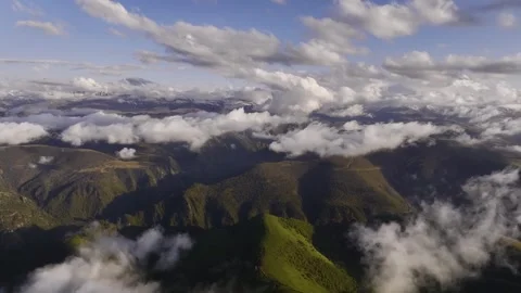 Aerial view of parallax clouds over a mountainous area. Videos summer mountain Stock Footage 245628727