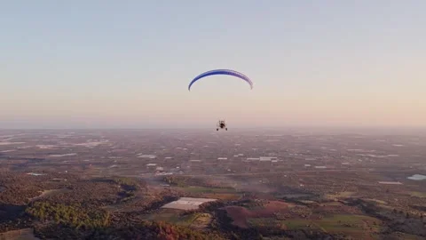 Aerial view of Paramotor flying at sunset over Ginosa, Taranto, Italy. Stock Footage 279761818