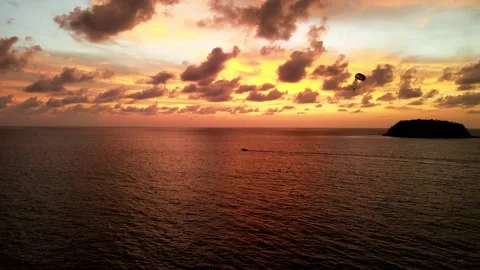Aerial View Of Parasailer Being Pulled By Boat Against Golden Orange 動画素材 201258364