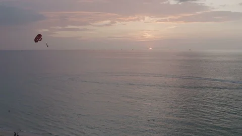 Aerial view parasailing passing sunset Stock Footage 101142993