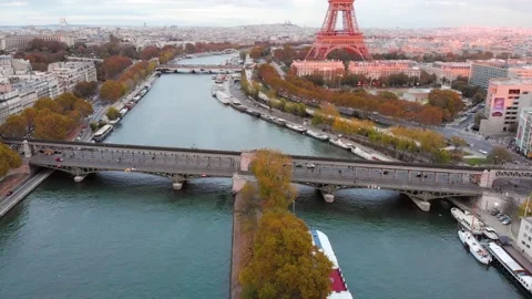 Aerial view of Paris Eiffel Tower and tram pass over Seine River bridge Stock Footage 131224079