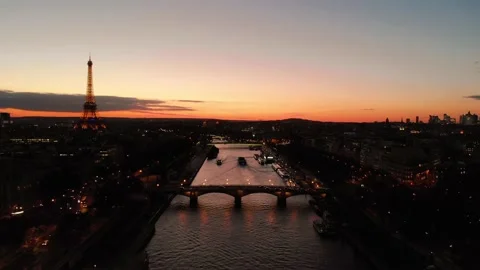 Aerial view of Paris Tour Eiffel Tower flying above Paris Seine River at sunset Stock Footage