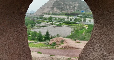 Aerial View Of Park Through Rock Cave With Circular Plaza Vídeos de archivo 312930066