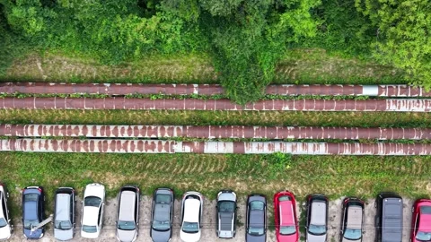 Aerial view of parked vehicles alongside rusty metal pipes Stock Footage 338352408