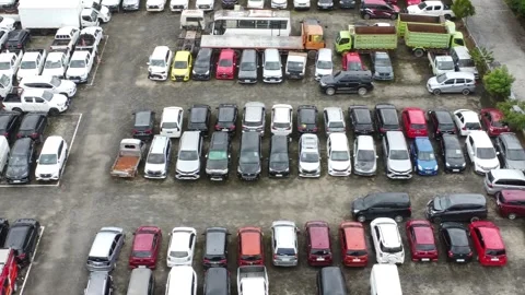 Aerial view of a parking lot lined up with cars for rent Stock Footage 325640369