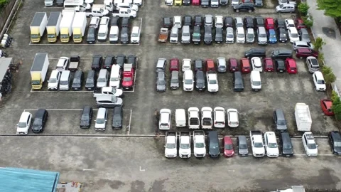 Aerial view of a parking lot lined up with cars for rent Stock Footage 326194973