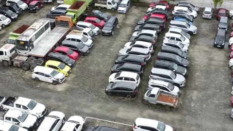 Aerial view of a parking lot lined up with cars for rent Stock Footage 327048407