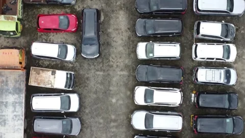 Aerial view of a parking lot lined up with cars for rent Stock Footage 327048557